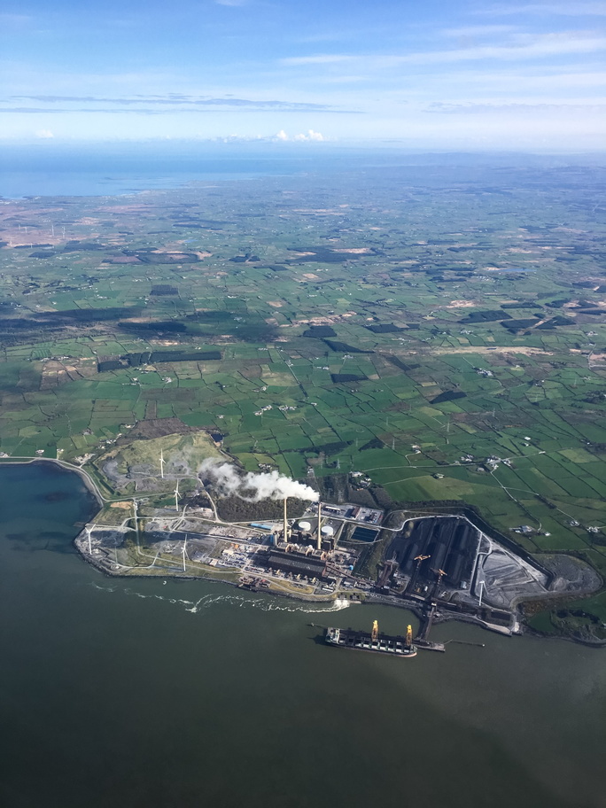 Ireland-0002-Powerplant with a HUGE amount of coal piled up in the lower right. Notice the new windmills installed right next to it..jpg